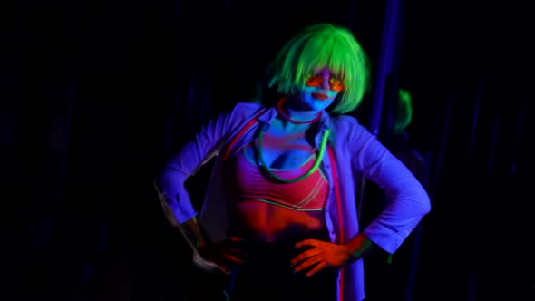a Woman with Green Hair and Red Glasses is Dancing on a Dark Background