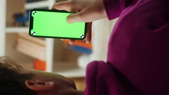 Vertical Video of Man Using Smartphone with Chroma Key Closeup