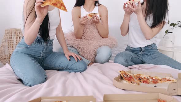Close-up of Cut Takeaway Pizza Shared By Girls in the Bed