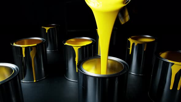 Yellow Paint Pouring. Paint Is Poured Into a Can