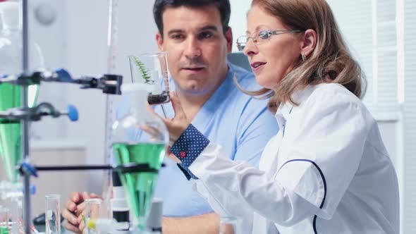 Biochemistry Scientist Showing a Sample To Her Assistant