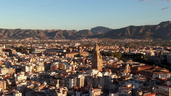 Drone shot orbiting the Cathedral of Murcia in Spain at sunset