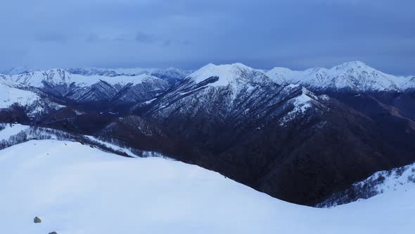 Snowy Mountain with Mountain Ridge in Front Revealing Snow Covered Mountain Range After Snowfall in