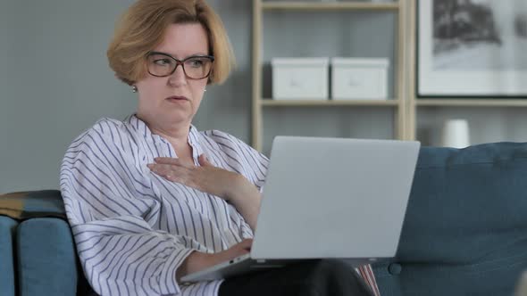 Shocked, Stunned Old Woman Wondering and Working on Laptop