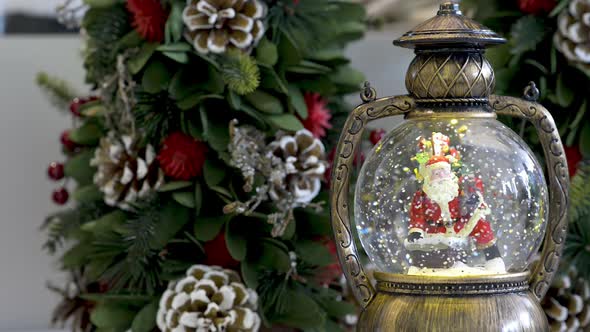 Snowglobe with Santa Clauss and Christmas decoration. Flat plane