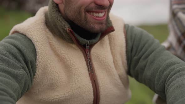 Smiling Man In Woolly Hat Laughing And Looking Away