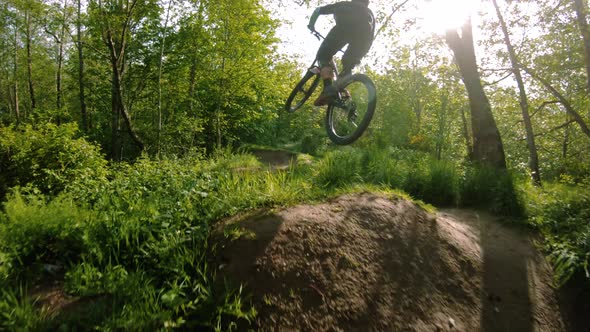 Stunning Mountain Bike Dirt Jump Slow Motion Stylish Air With Sun Rays alt