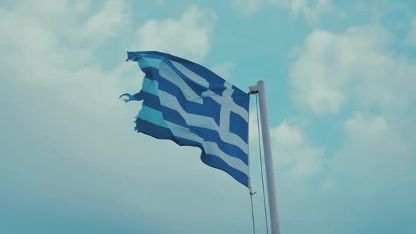 Worn Greek flag blowing in the wind overcast sky 180 FPS