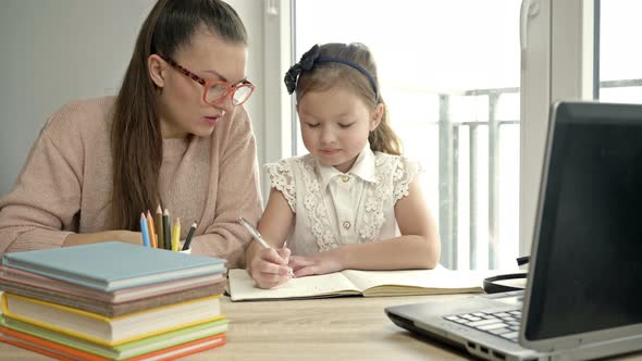 Mom Helps Little Elementary School Student Her Homework