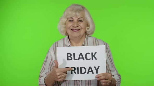 Elderly Grandmother Holding Black Friday Text Inscription Banner, Senior Woman Rejoicing Discounts