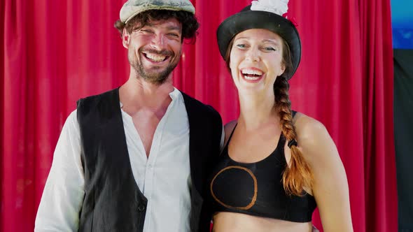 Happy artist couple laughing in circus tent