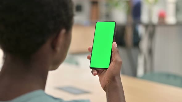 African Man Using Smartphone with Green Chroma Screen 