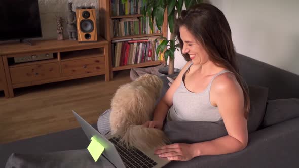 Woman Works From Home and Plays with the Dog During a Pandemic in Slow Motion