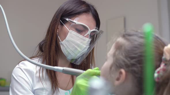 Dentist Cleans Girl's Teeth with Professional Toothpaste