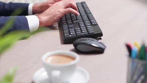 Businessman at His Desk Using a Computer Keyboard