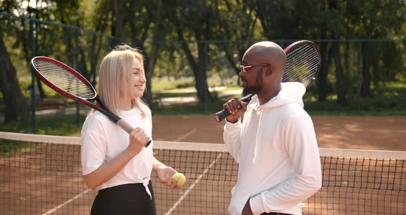 Couple of Tennis Players Having a Conversation at Court