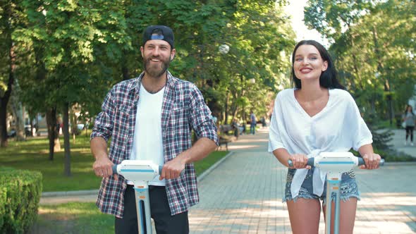 Man and Woman Riding Motorized Bike