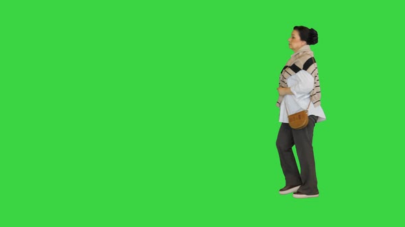 Mature Woman in White Shirt Walking By on a Green Screen Chroma Key