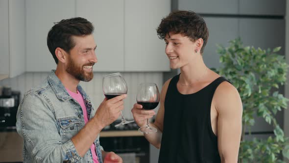 Lgbt Couple Standing in Their New Apartment Drinking Wine From the Glasses Feeling Happy and Inlove