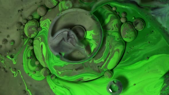 Green and grey acrylic chemical reaction. Slow motion.