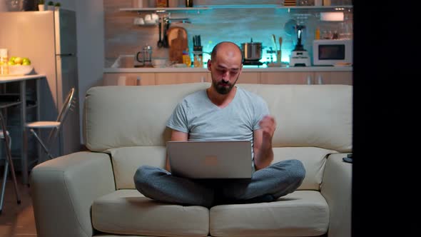 Tired Man in Pajams Browsing on Internet Lifestyle Information