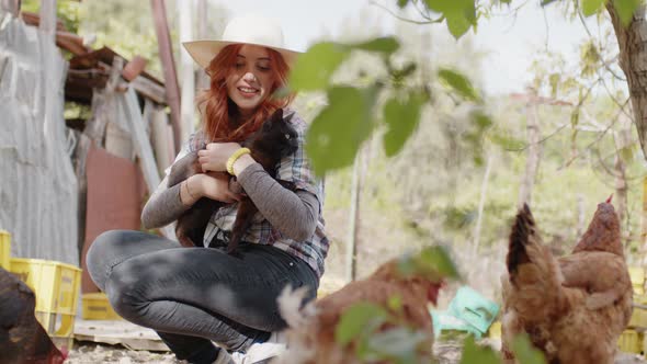 Young Peasant Girl Strokes the Cat in the Countryside Near the Hens