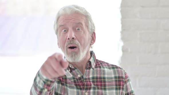 Portrait of Casual Old Man Pointing Finger at Camera and Inviting