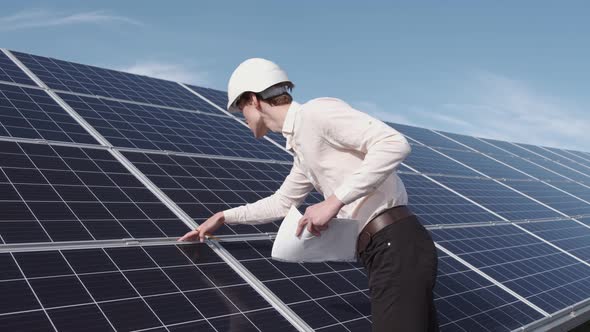 A Man Is Checking the Solar Power Panel at the Plant