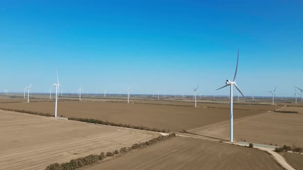 Aerial View of Wind Turbine Farm on Agriculture Fields in Ukraine on Clear Blue Sky Background