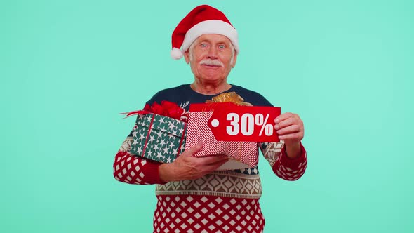 Senior Man in Christmas Sweater Showing Gift Box and 30 Percent Discount Inscriptions Banner Text