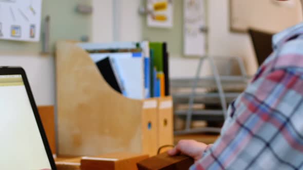 Female executive working over laptop at her desk