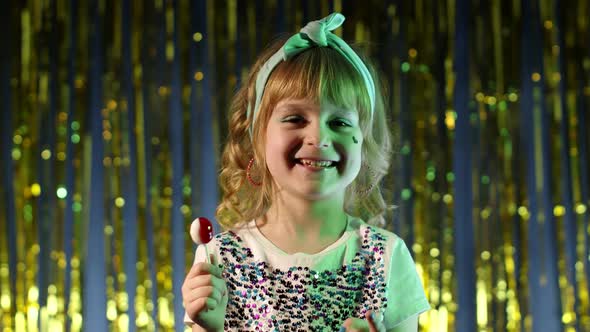 Stylish Child Girl with Lollipop Candy Looking at Camera Smiling Screaming Shouting at Disco Club