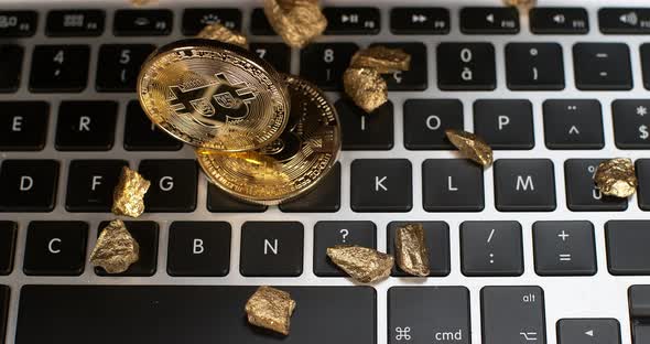 Bitcoins on Computer Keyboard Background, Slow Motion 4K