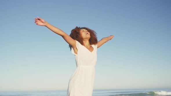 African American woman enjoying the fresh air of the beach