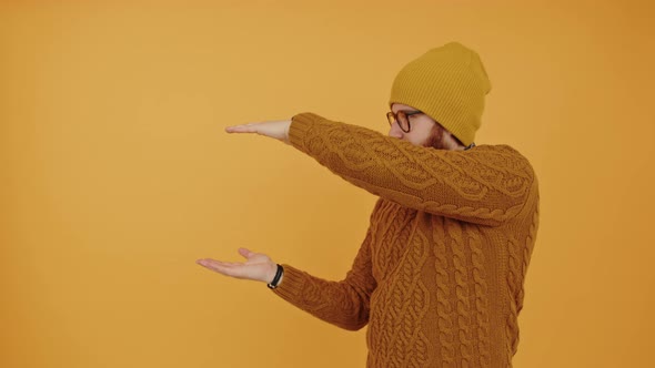 Video Portrait Young Bearded Caucasian Man Measures Something with His Hands and Looks at the Camera