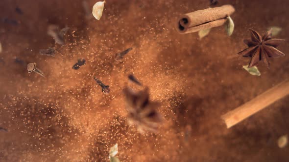 Cinnamon Sticks and Powder with Spices Flying and Falling in Slow Motion