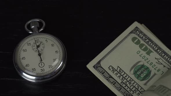 Dollars and stopwatch. Business concept of lost time and failed investments
