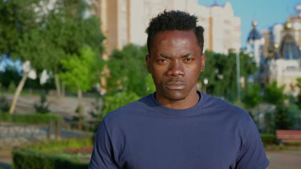 Close Up Serious Patriot AfroAmerican Man Holding American Flag Looks Camera