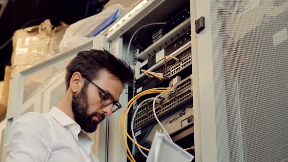 Admin Repairing Render Farm. Engineer On Cluster Console In Artificial Intelligence Server Room.