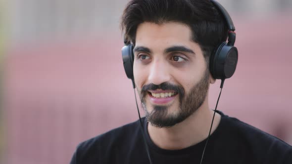 Happy Bearded Young Indian Arabic Man Wearing Headphones Enjoy Music Smiling Dark Haired Middle