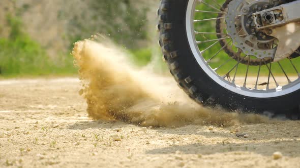 Close Up Wheel of Powerful Off-road Motorcycle Starting Movement. Motocross Bike Starts Move. Dry