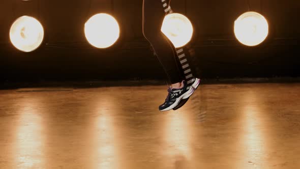 Beautiful Woman Working Out In Front Of A Wall Of Lights