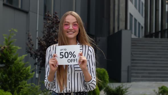 Teen Girl Showing Up To 50 Percent Off Inscription, Advertising Discounts, Shopping on Black Friday