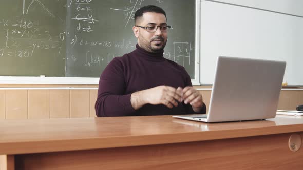 Mixed-Race Professor Having Online Maths Lesson in Class