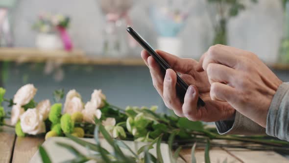 Florist Scrolling Feed On Smartphone