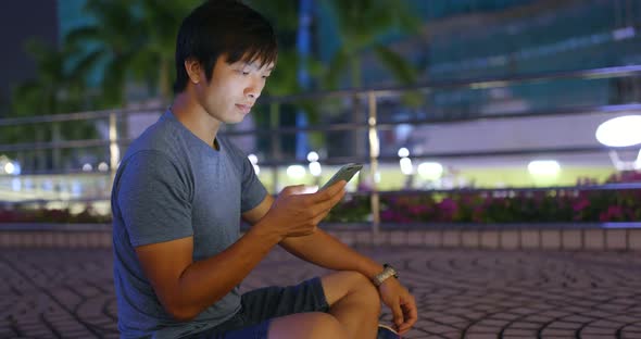 Young man use of cellphone at night