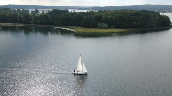 Aerial view of a sailboat on a lake in Masuria (Mazury) region in Poland, Europe