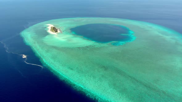 Aerial: Flying over idyllic atoll, exotic travel destination in Wakatobi National Park, Indonesia