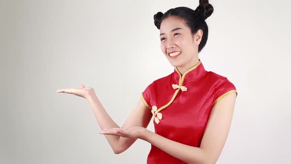 woman wear red cheongsam with open hand palm in concept of happy chinese new year