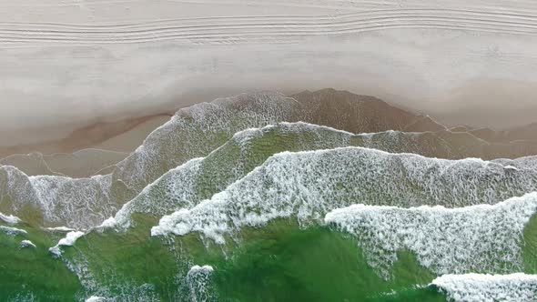 Top-down aerial view of the beach at the sea